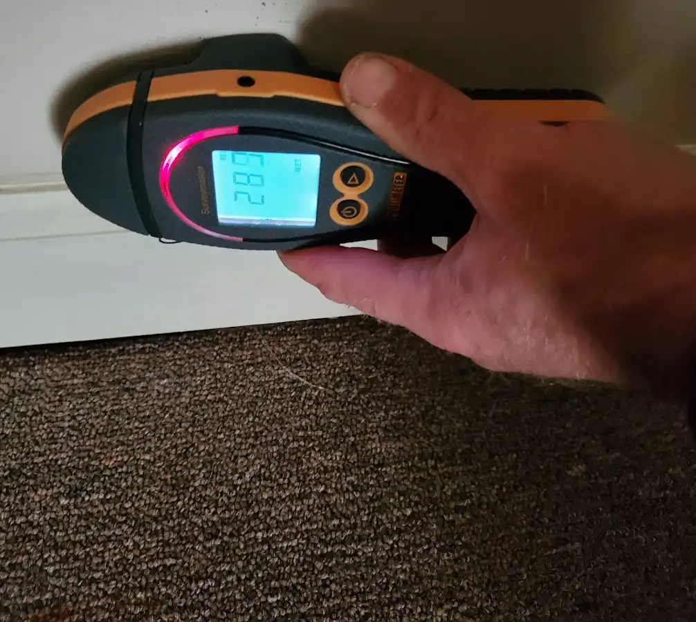 Moisture detection at baseboard during Storm Damage Restoration in Roxborough Park